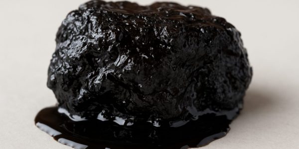 Close-up of a piece of shilajit on a neutral background